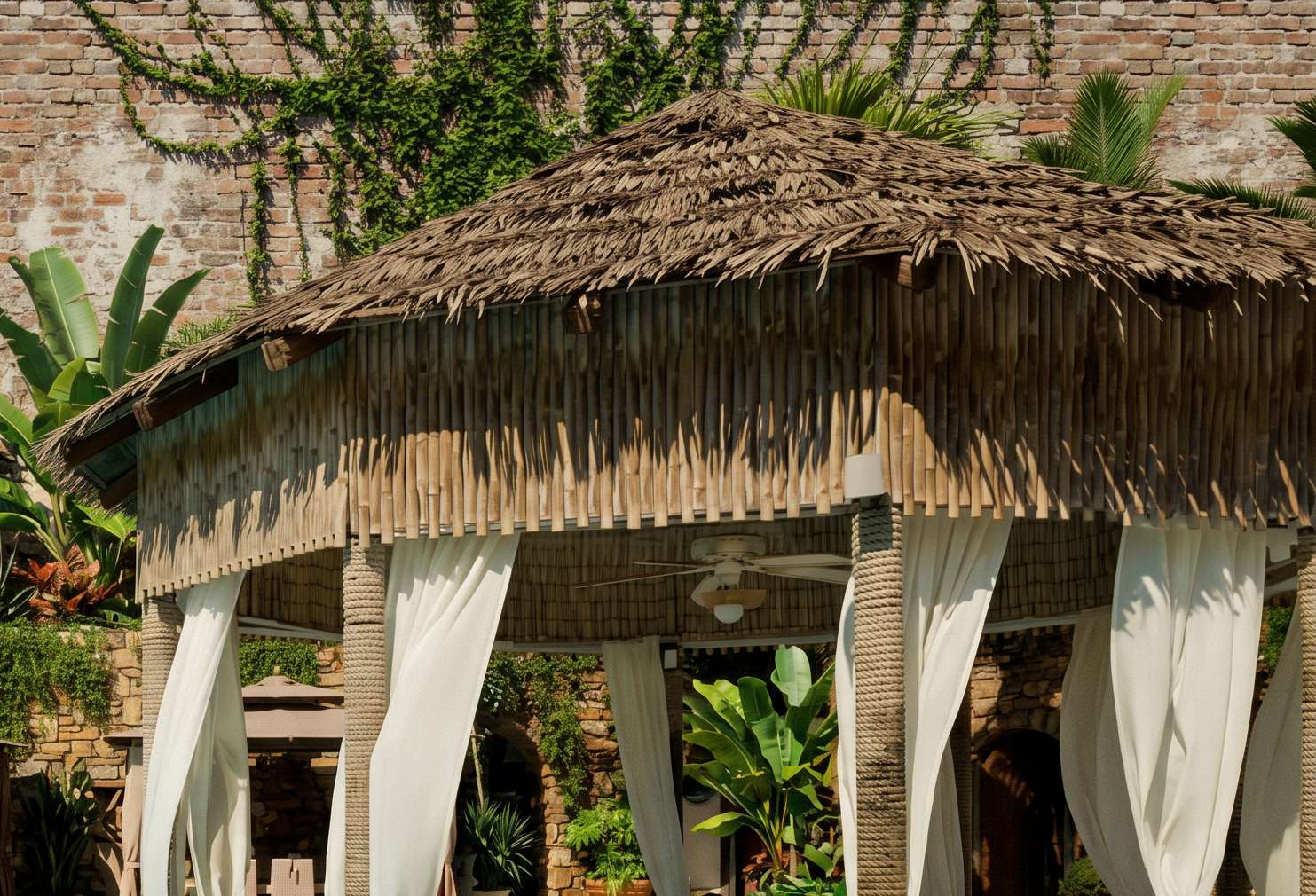 Pool gazebo with white curtains and thatched roof.